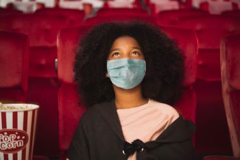 Girl watching movie in theater