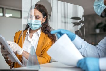 Female bank teller wearing mask