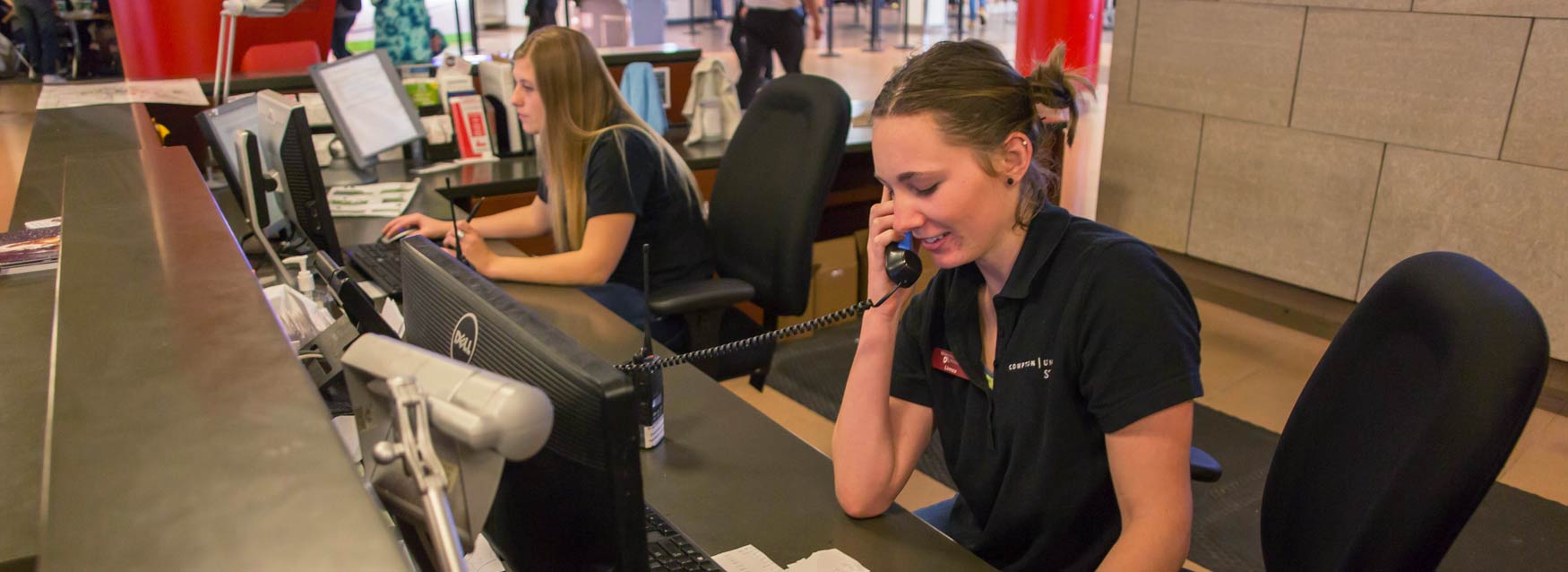 Student staff take phone calls at info desk