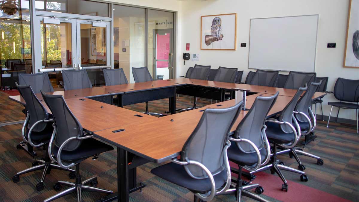 A room with a table and chairs in the center